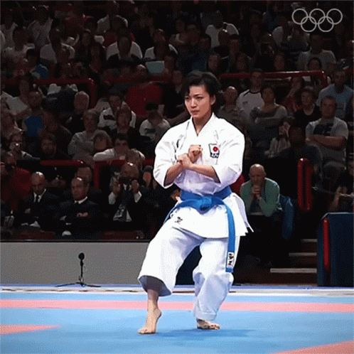 Woman in White Karate Uniform with Blue Belt