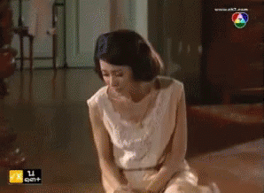 Woman In White Kneeling At TV Saying Ek7.com GIF