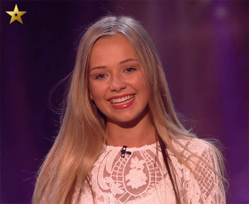 Woman In White Lace Top Smiling With Gold Star GIF