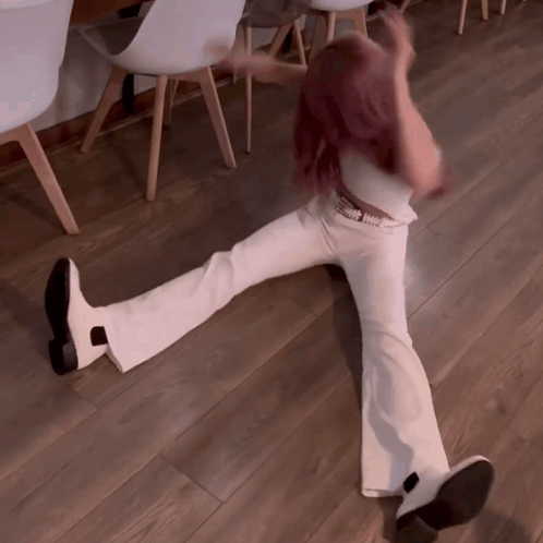Woman In White Pants Laying On Floor GIF