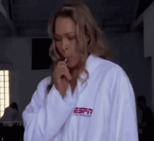 Woman in White Robe Holding Lollipop