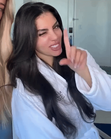Woman in White Robe Saying Victoria