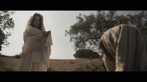 Woman in White Robe Standing in Field