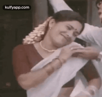 Woman In White Saree Next To Man In Red Shirt GIF