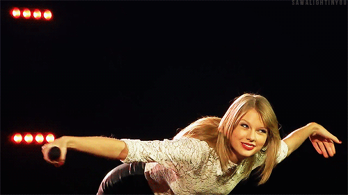 Woman In White Shirt And Black Shorts Holding Microphone GIF