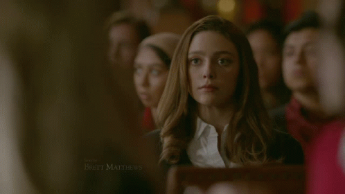 Woman in White Shirt and Black Sweater Brett Matthews