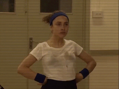 Woman in White Shirt and Blue Headband at Door