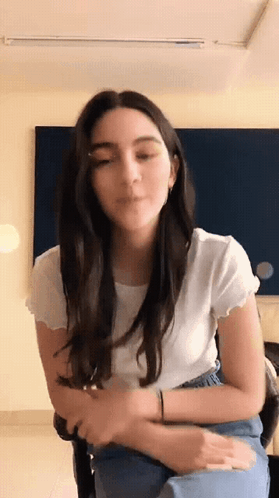 Woman in White Shirt and Blue Jeans Sitting