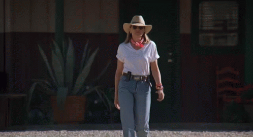 Woman in White Shirt and Cowboy Hat Walking