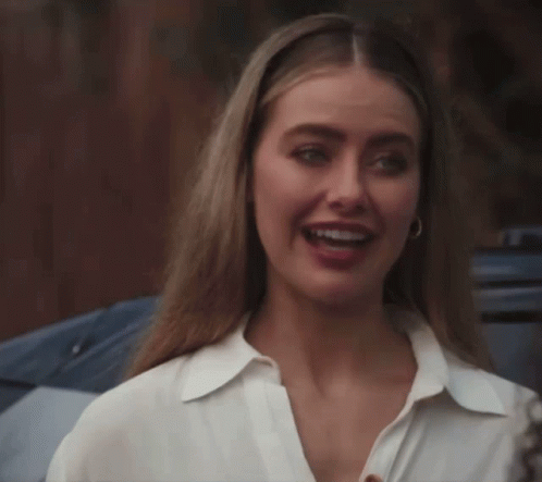 Woman In White Shirt And Hoop Earrings Smiling GIF