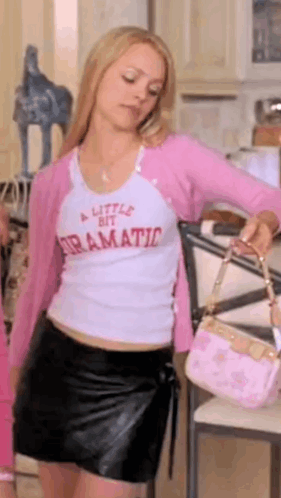 Woman in White Shirt and Pink Cardigan Holding Pink Bag