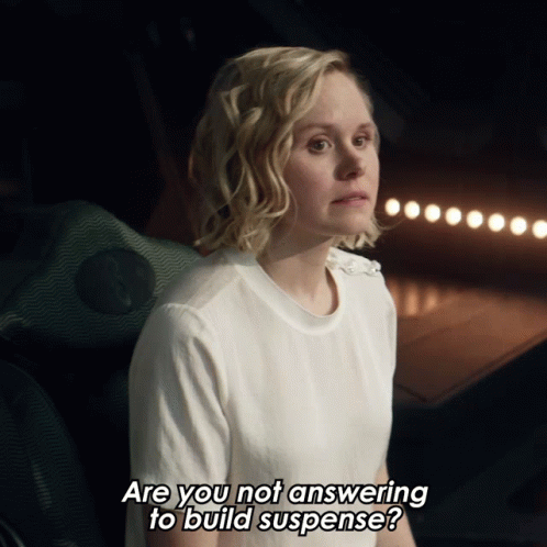 Woman in White Shirt Asking If She Is Answering to Build Suspense