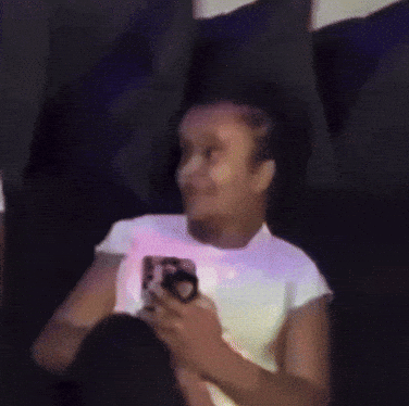 Woman in White Shirt Holding Cell Phone