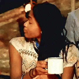 Woman in White Shirt Holding White Cup