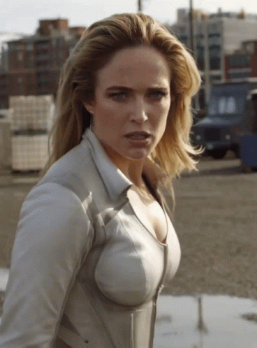 Woman In White Shirt Looking At Camera GIF