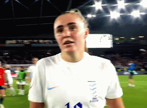 Woman in White Shirt Number 10 on Soccer Field