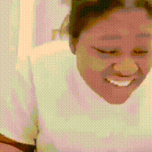 Woman in White Shirt Smiling Eyes Closed