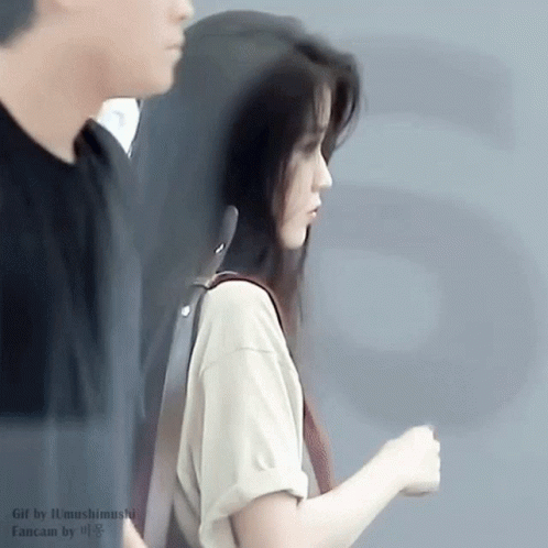 Woman in White Shirt Standing with Man