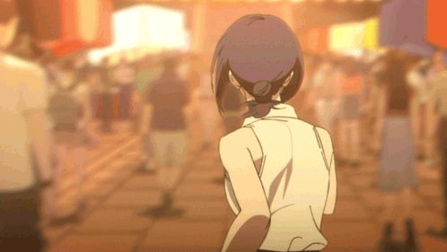 Woman in White Shirt Walking in Crowded Street