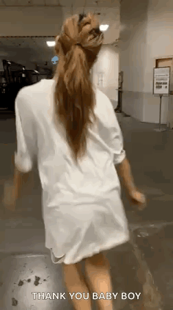 Woman in White Shirt Walking With Ponytail
