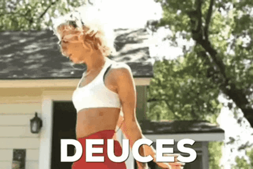 Woman in White Sports Bra Red Shorts Deuces House