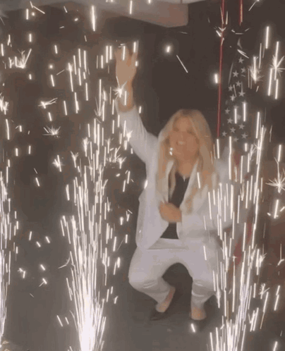 Woman In White Suit Dancing Fireworks GIF