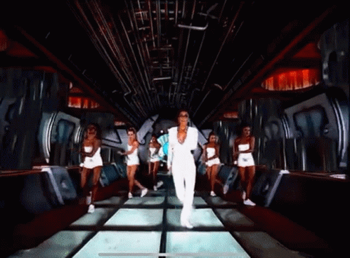 Woman In White Suit Dancing With Group In White Shorts GIF