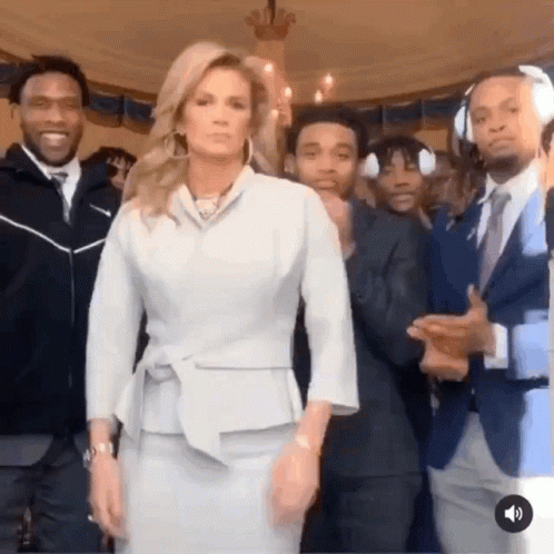 Woman in White Suit in Front of Men
