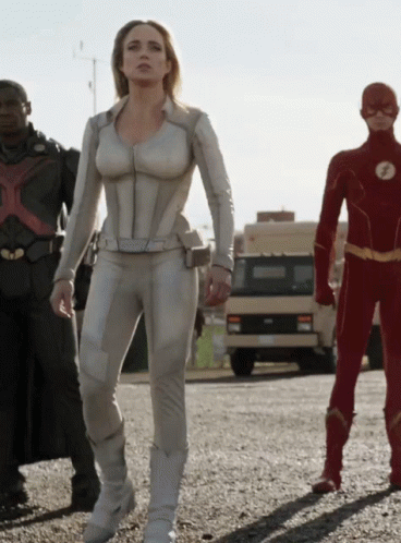 Woman In White Suit Next To Men In Red And Black Suits GIF