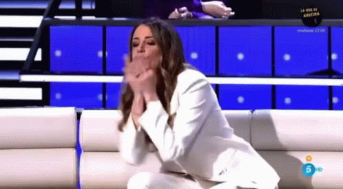 Woman In White Suit On Couch Hands Folded GIF