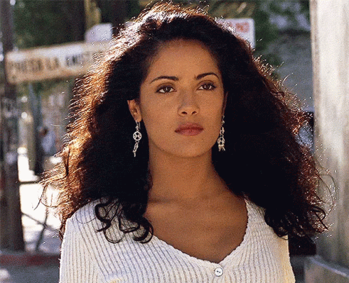 Woman in White Sweater and Earrings at Puerta La Ermita