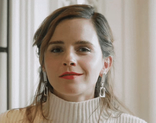 Woman in White Sweater and Silver Earrings