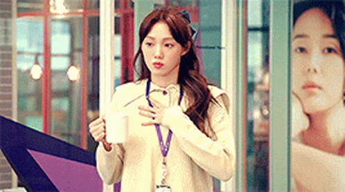 Woman in White Sweater Holding Coffee