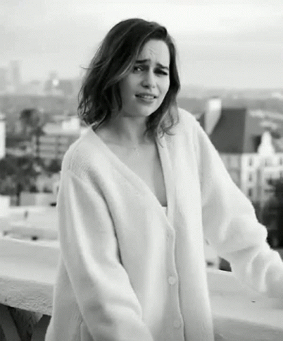 Woman in White Sweater on Balcony