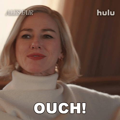 Woman in White Sweater Says Ouch