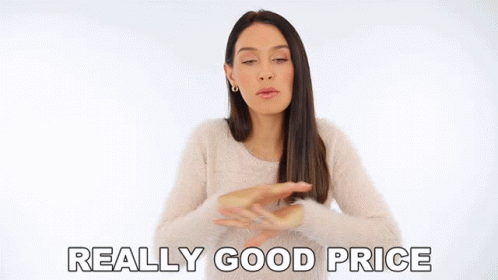 Woman in White Sweater Says Really Good Price Arms Outstretched