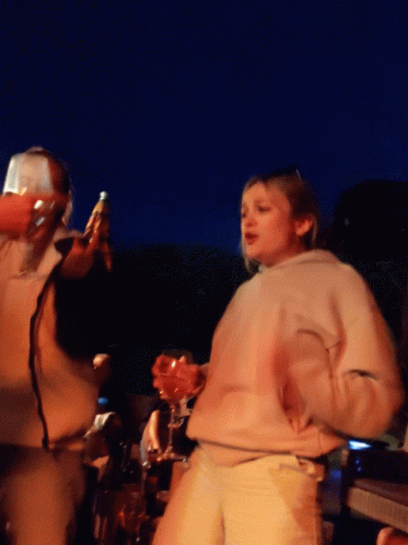 Woman In White Sweatshirt Holding Wine Glass GIF