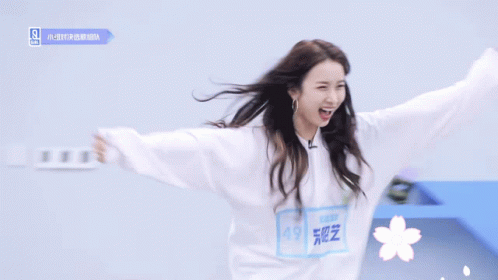 Woman In White Sweatshirt With Flower GIF