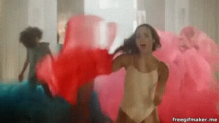 Woman in White Swimsuit Dancing with Group in Pink and Blue
