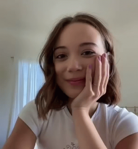 Woman In White T-Shirt Hand To Face Smiling GIF