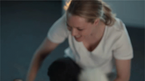 Woman in White T-Shirt Kneeling on Floor