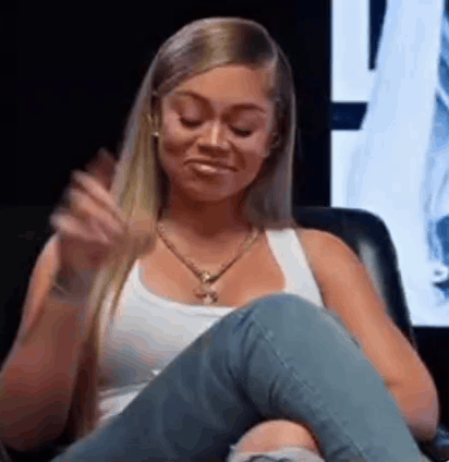 Woman in White Tank Top and Jeans Sitting Crossed Legs