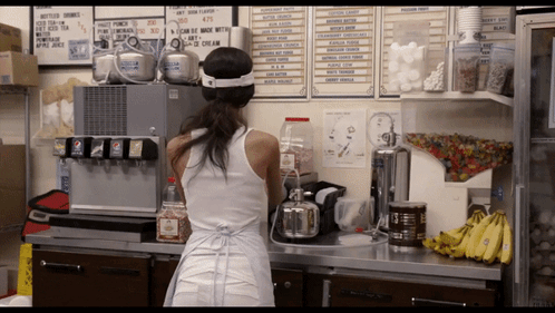 Woman in White Tank Top at Pepsi Machine