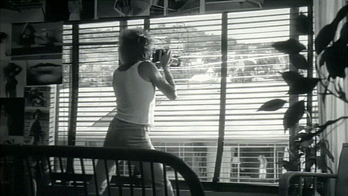 Woman in White Tank Top by Window