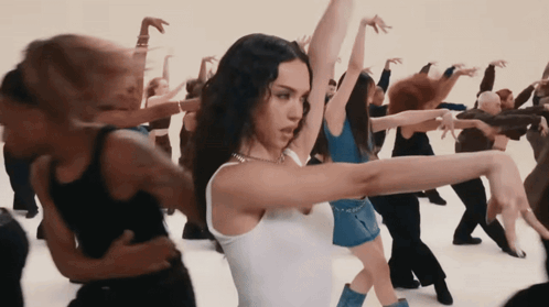 Woman in White Tank Top Dancing in Crowd