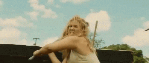 Woman in White Tank Top Holding Sword with Funny Face