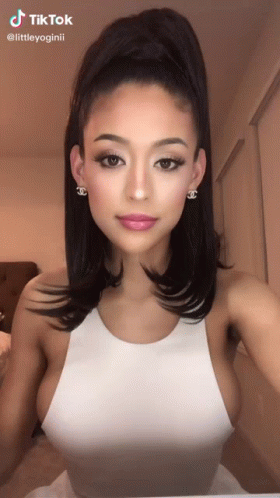 Woman in White Tank Top, Ponytail, Chanel Earrings
