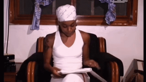 Woman In White Tank Top Sitting In Chair GIF
