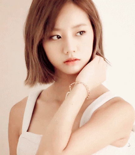 Woman in White Tank Top Touching Chin