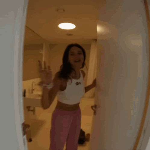 Woman In White Tank Top With SDX GIF